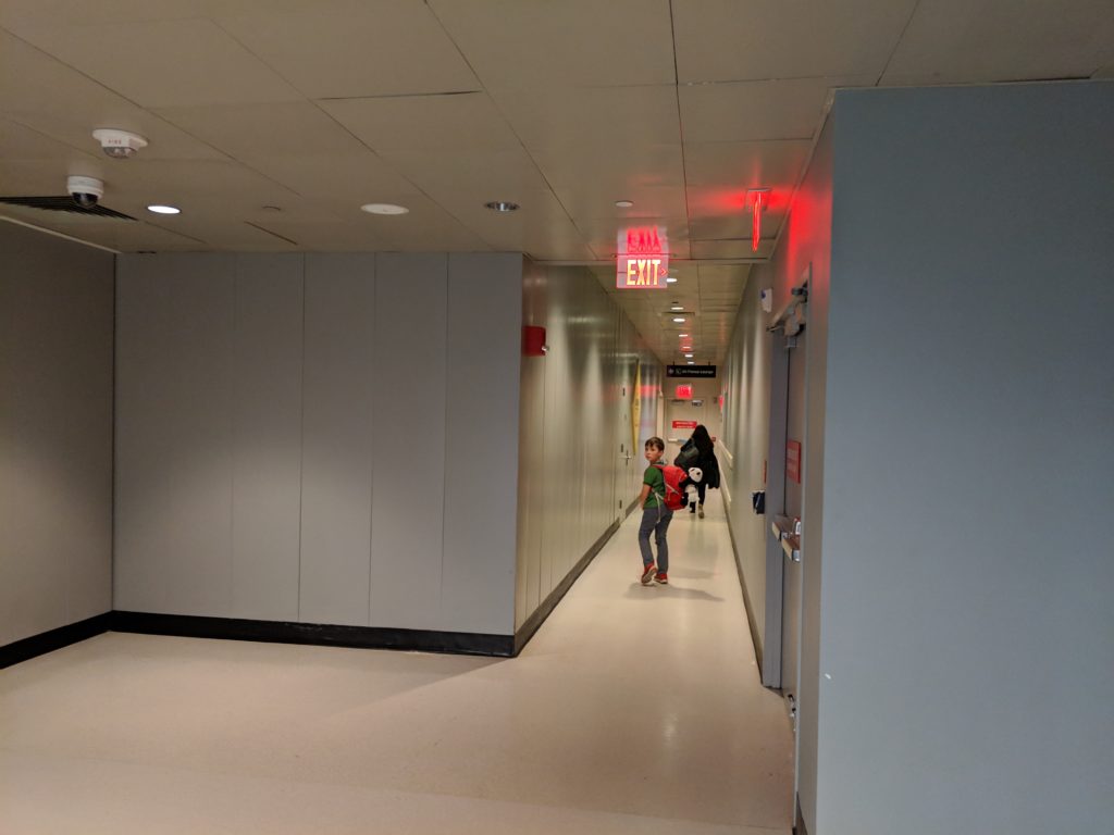 a boy walking in a hallway