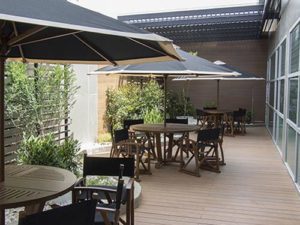 a patio with tables and umbrellas