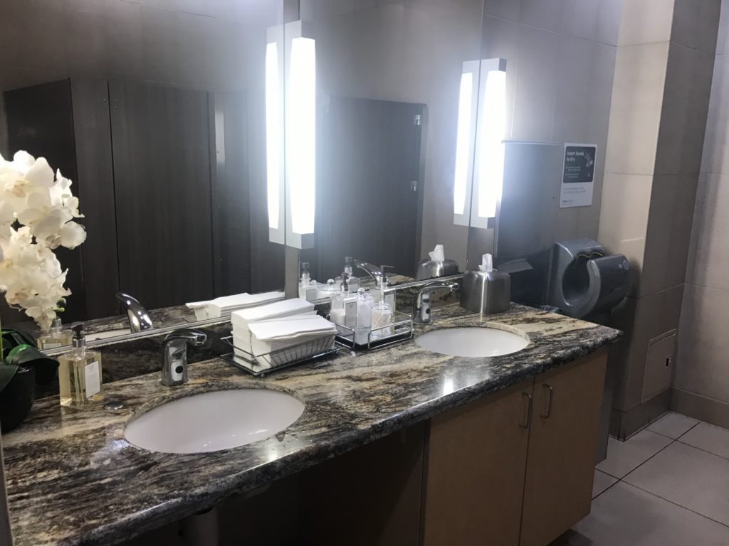 a bathroom with two sinks and a mirror
