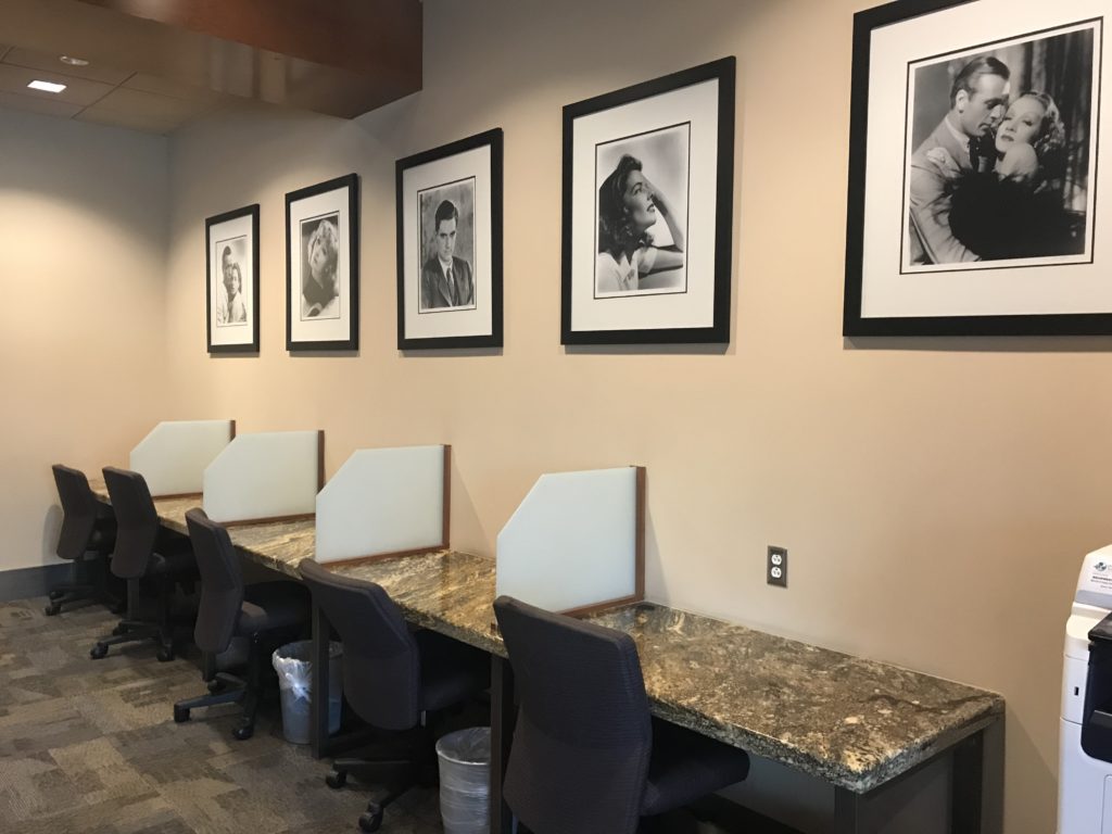 a row of chairs and tables with pictures on the wall