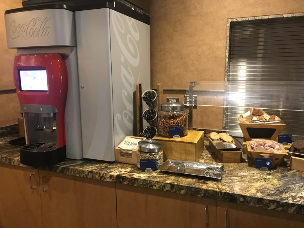 a counter with a machine and food items on it
