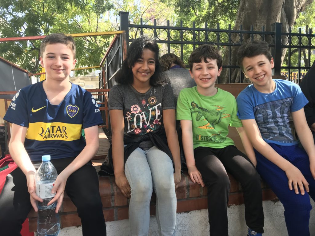 a group of kids sitting on a bench
