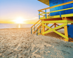a yellow and blue lifeguard tower on a beach
