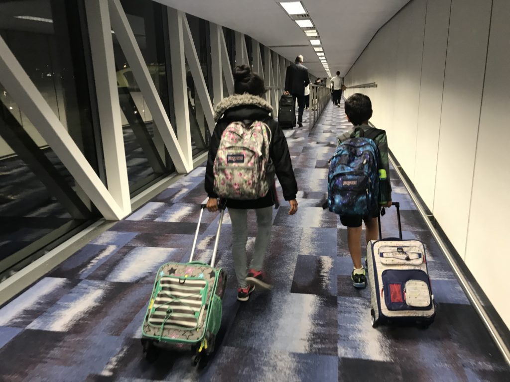 a group of people with luggage in a hallway
