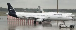 a white airplane on a wet runway