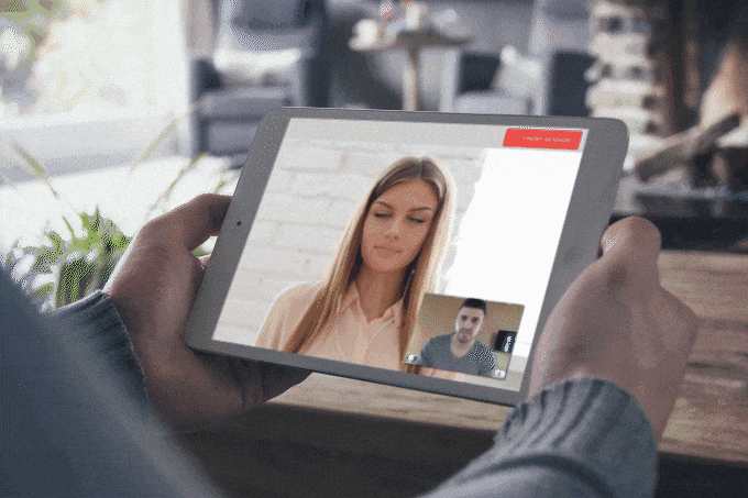 a person holding a tablet with a woman on it