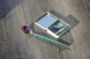 a spoon and fork in a tin box