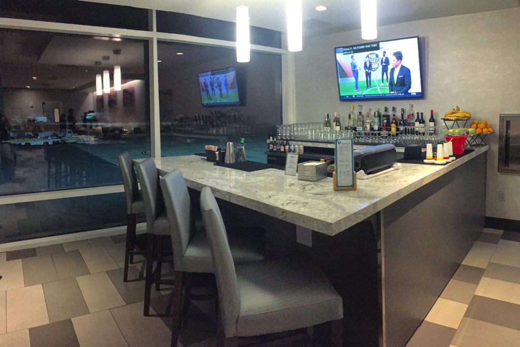 a bar with a television and a television on the wall