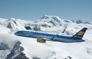 a plane flying over snowy mountains
