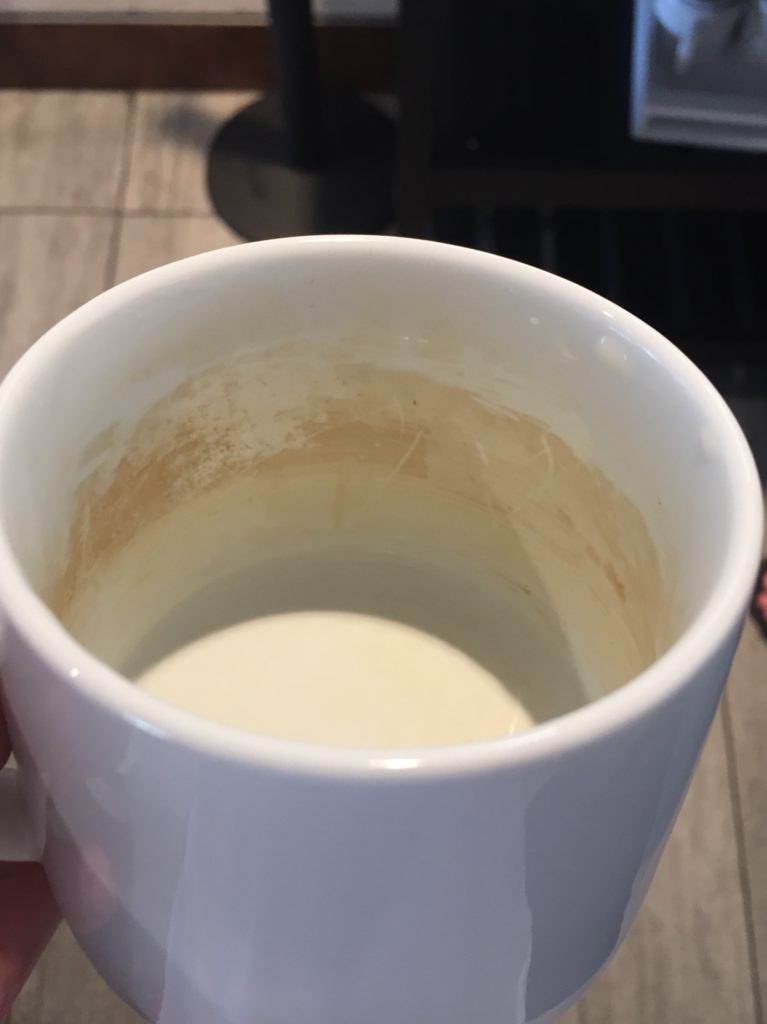 a white mug with a brown stain