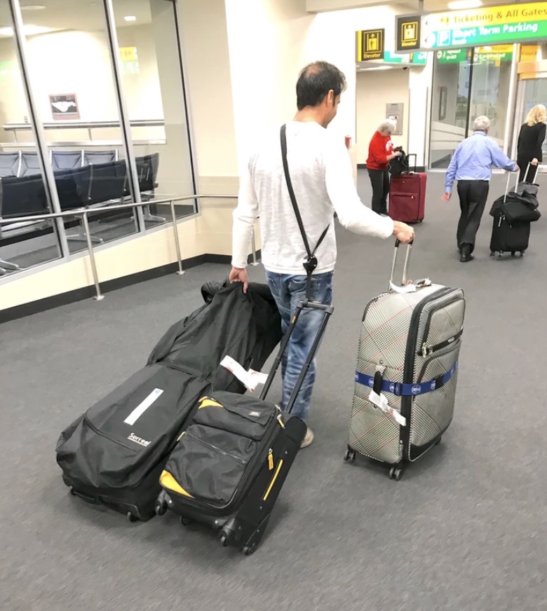 a man pulling luggage in an airport