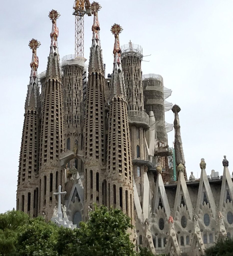 a large building with towers and towers with Sagrada Família in the background