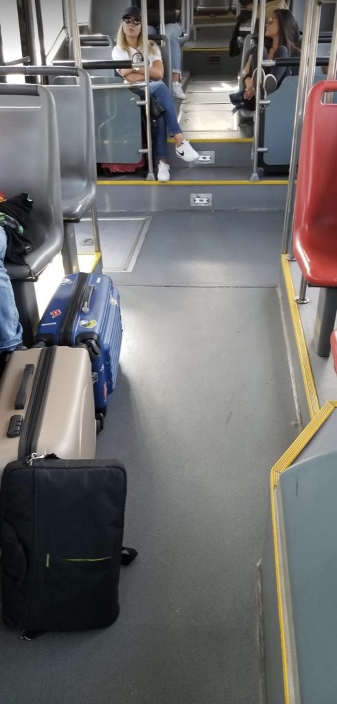a group of luggage on a bus
