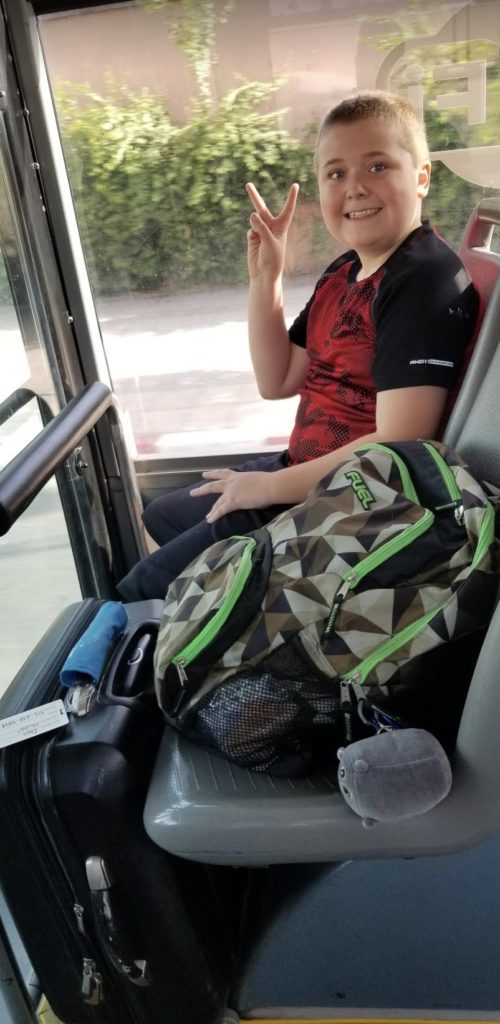 a boy sitting in a bus