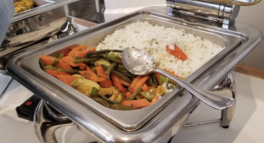a tray of food with a spoon
