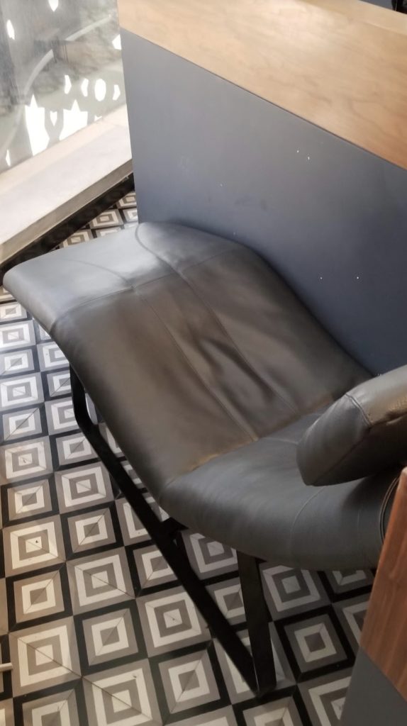 a black leather chair in a room