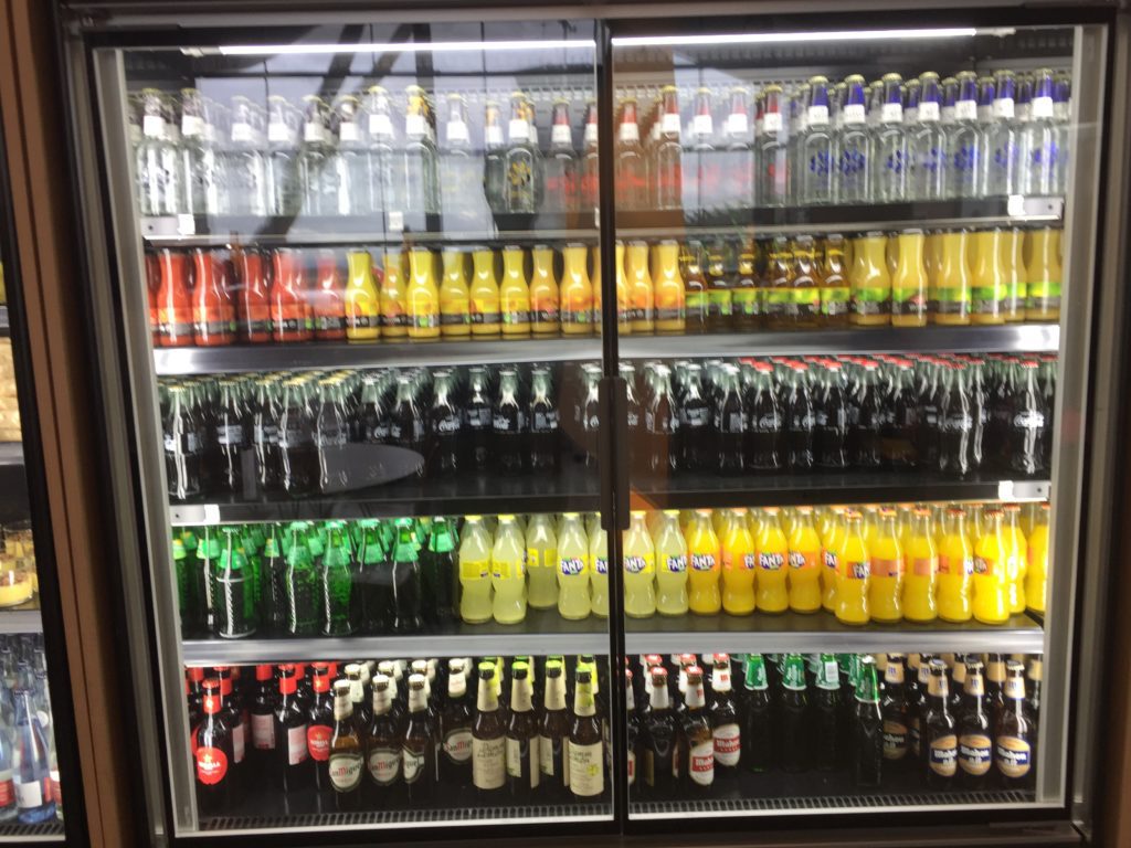 a display case with bottles of drinks