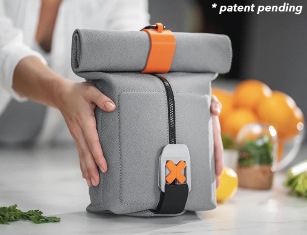 a person holding a grey and orange bag