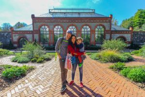 a man and woman posing for a picture in front of a building