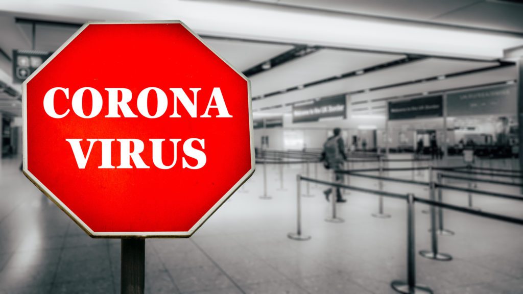 A sign says coronavirus in a nearly empty airport.