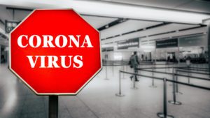 A sign in a nearly empty airport says coronavirus.