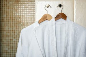 Twp hotel bathrobes are on hangers.