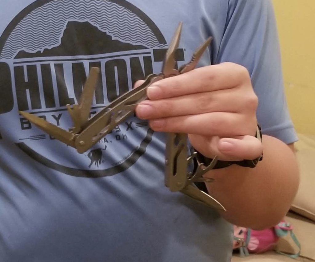 a person holding a multi tool