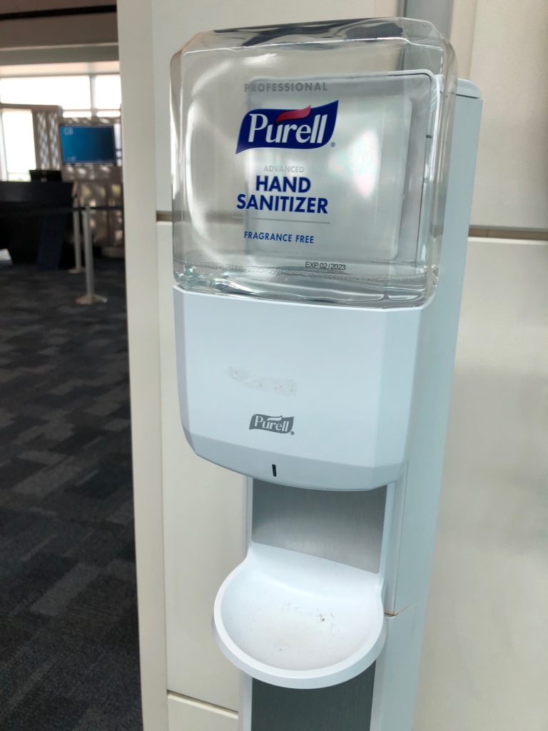 a hand sanitizer dispenser in a room
