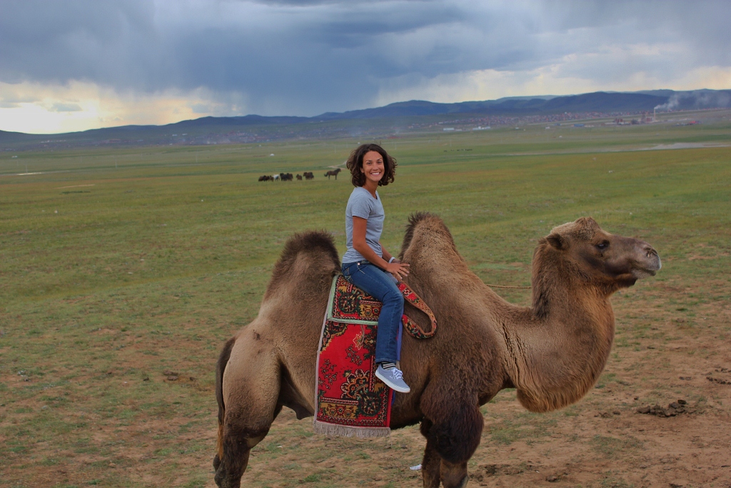 a woman riding a camel