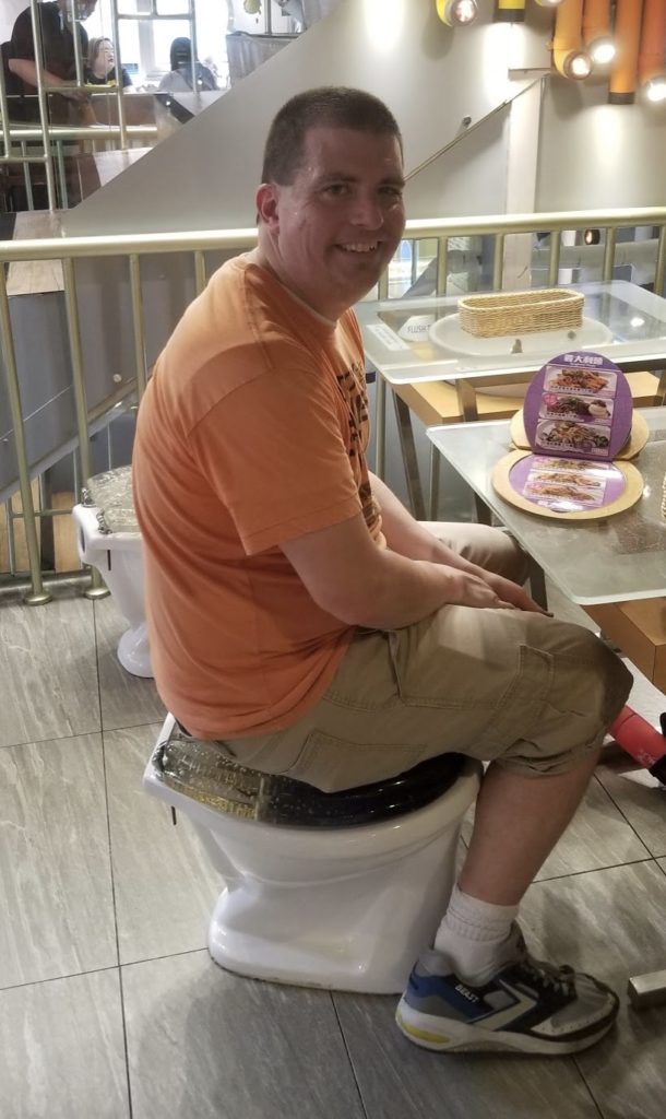 a man sitting on a toilet