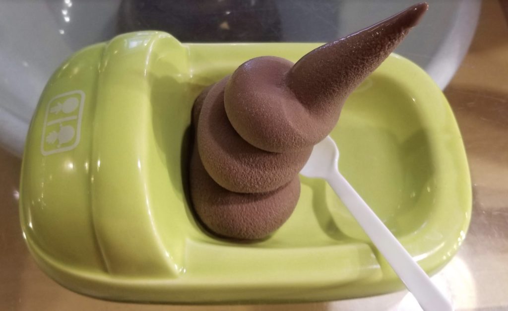 a pile of chocolate ice cream in a green container