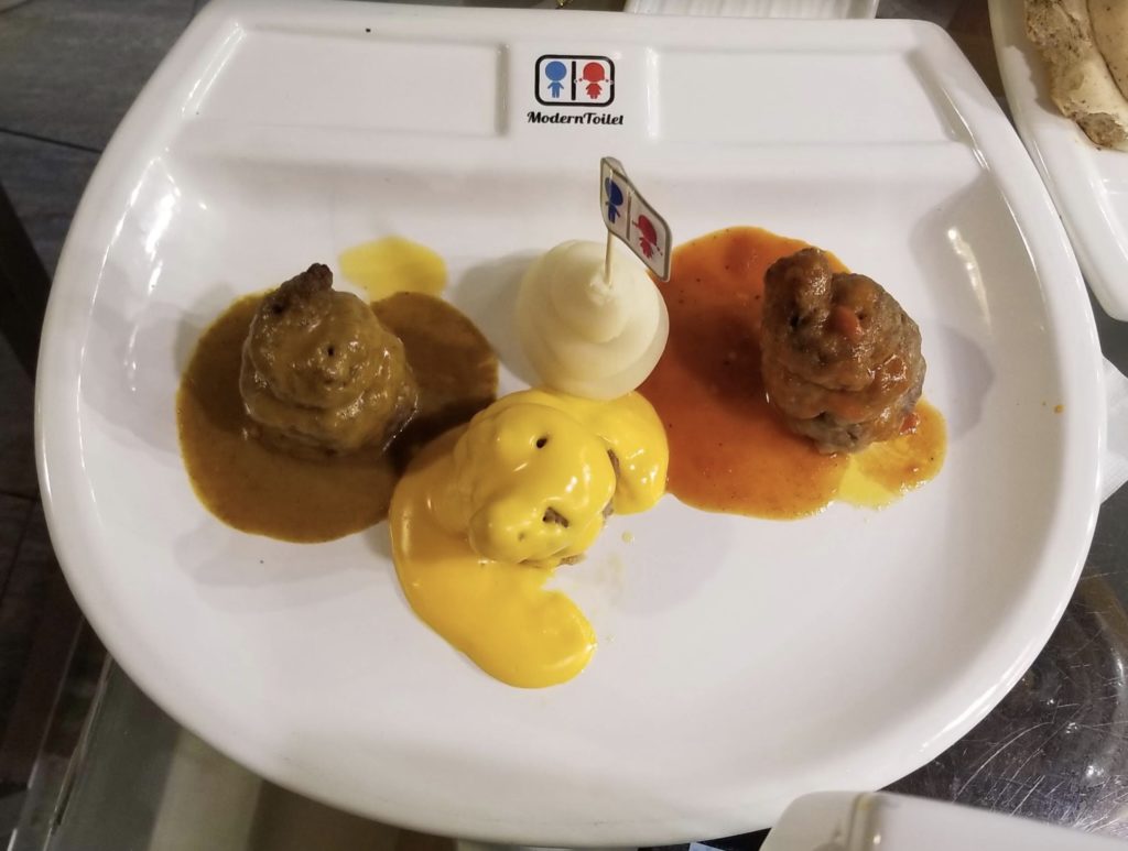 a plate of food with a sign on it