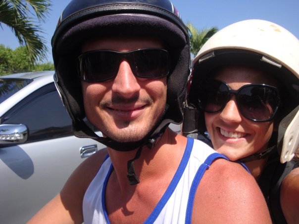 a man and woman wearing helmets and sunglasses