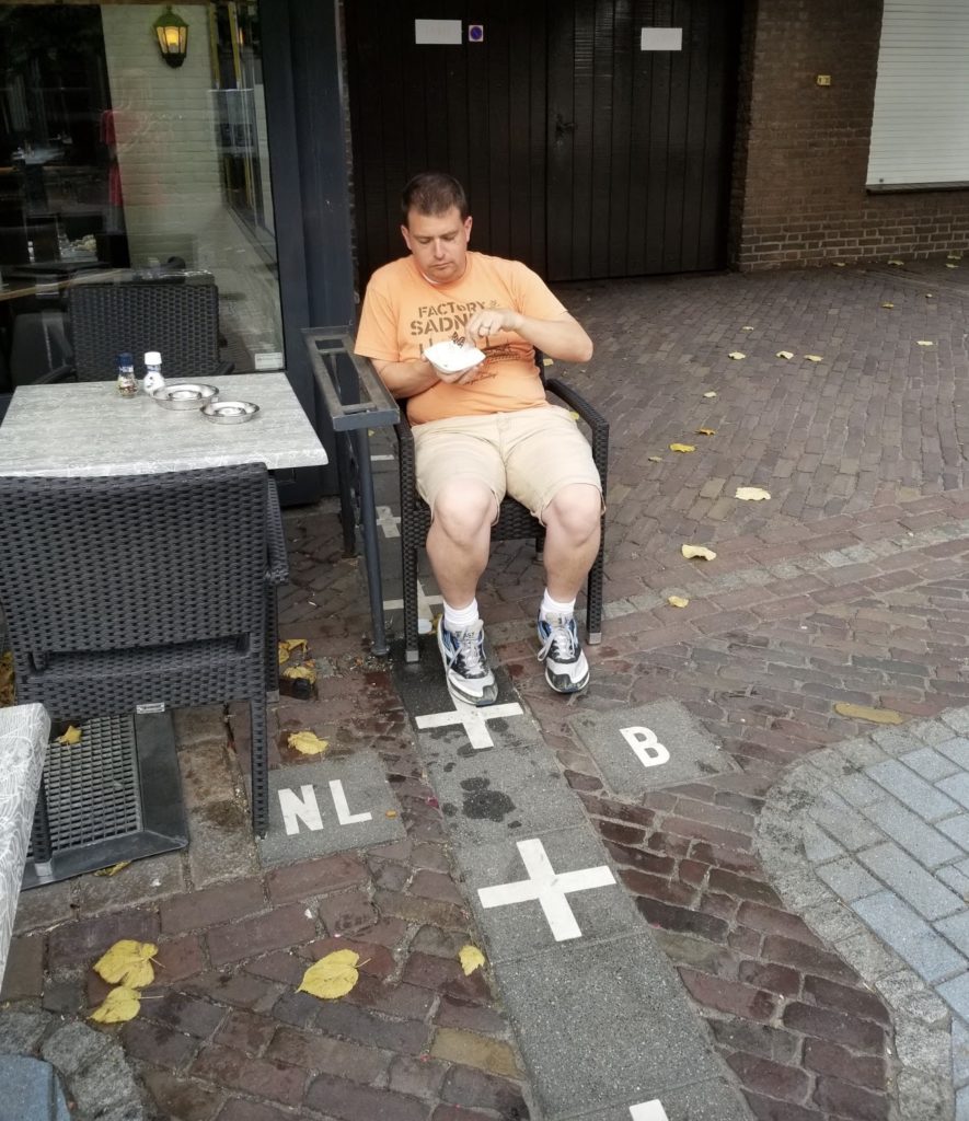 a man sitting in a chair outside