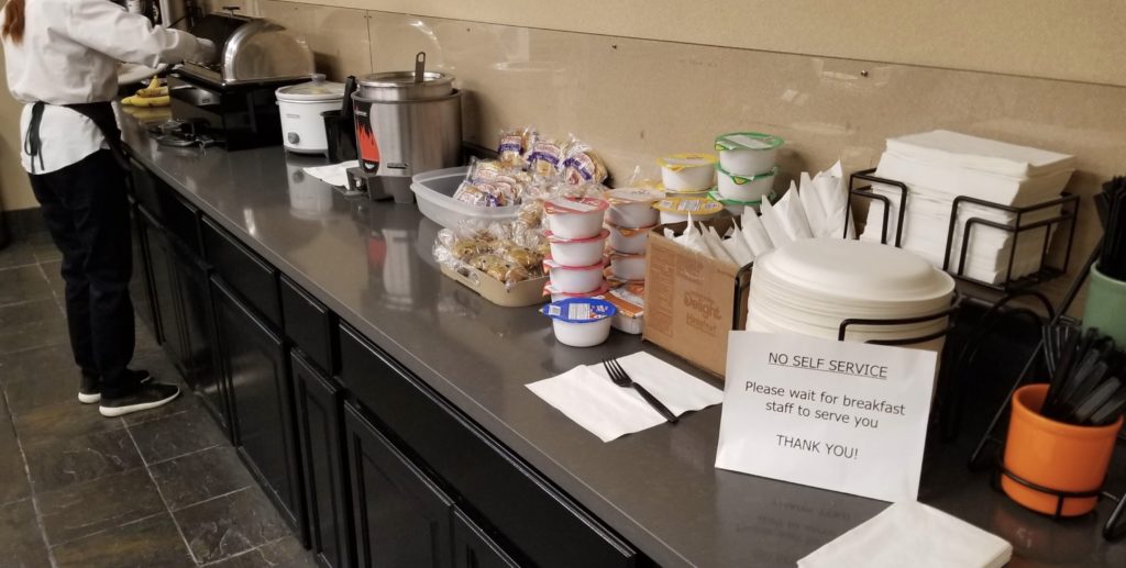 a counter with food items and a sign