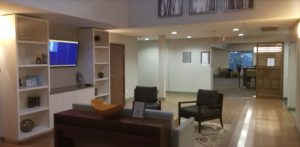 a room with a tv and a reception desk