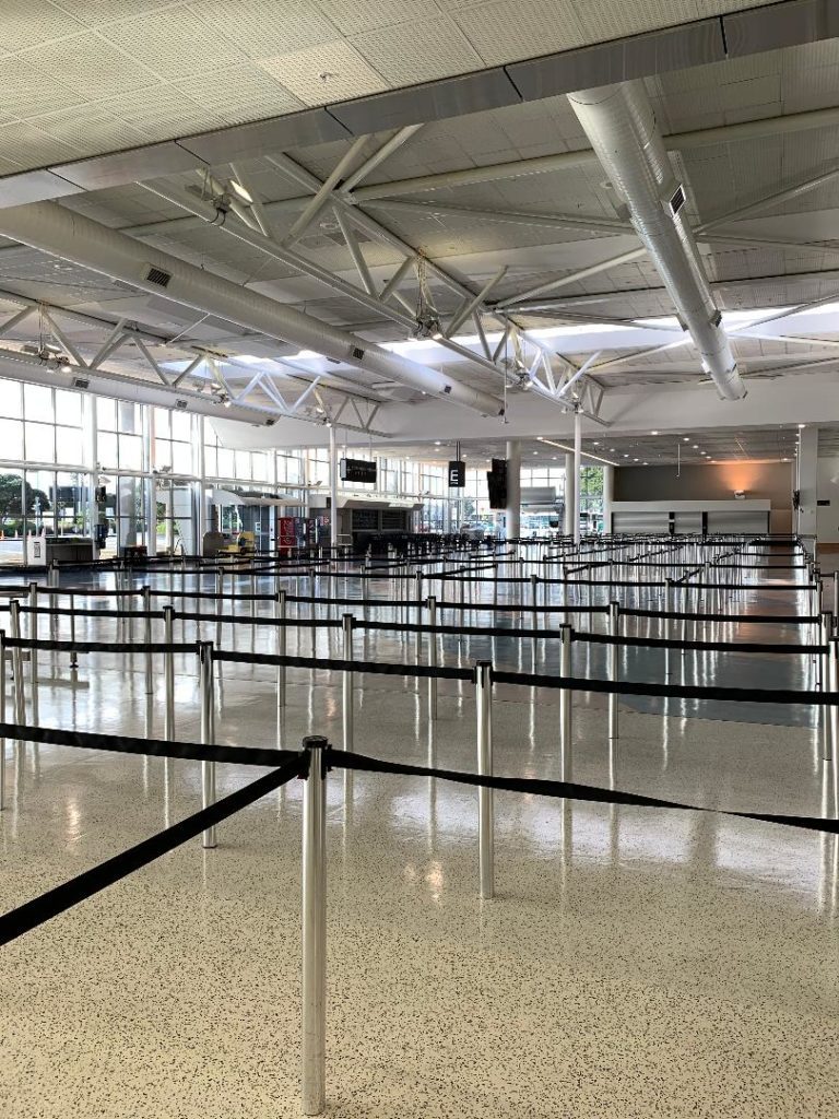 a large airport terminal with black ropes