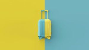 a blue and yellow suitcase on a yellow and blue background