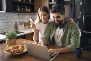 a man and woman looking at a laptop