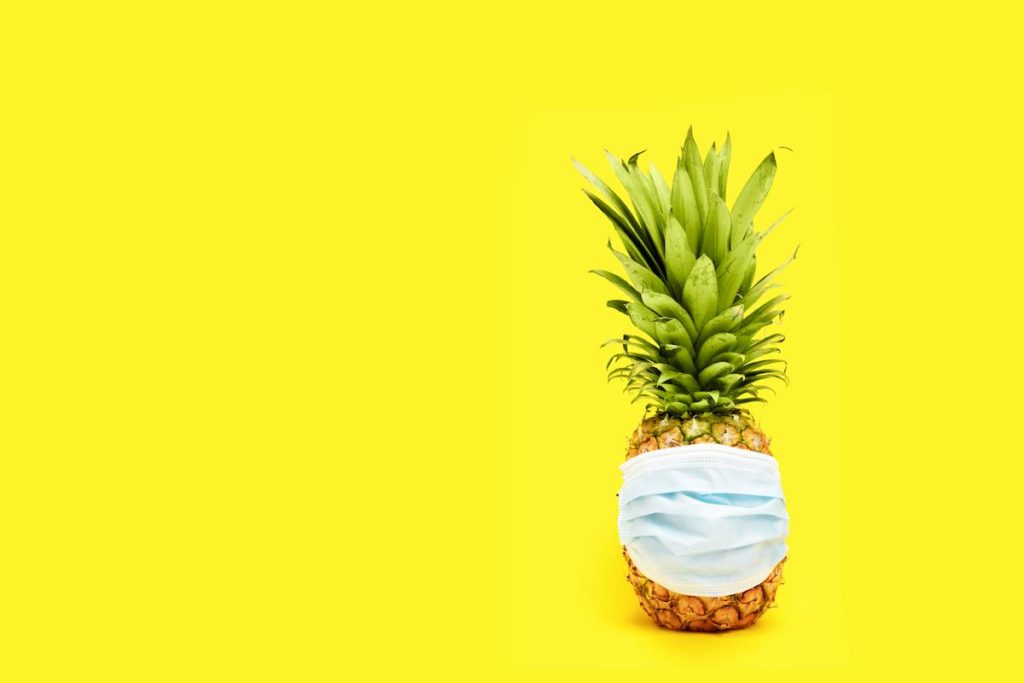 a pineapple wearing a face mask