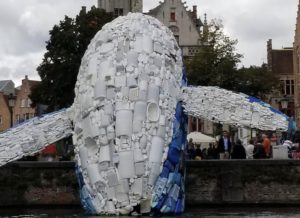 a sculpture of a whale made of plastic bottles