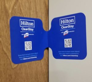 a blue and white sticker on a wood surface