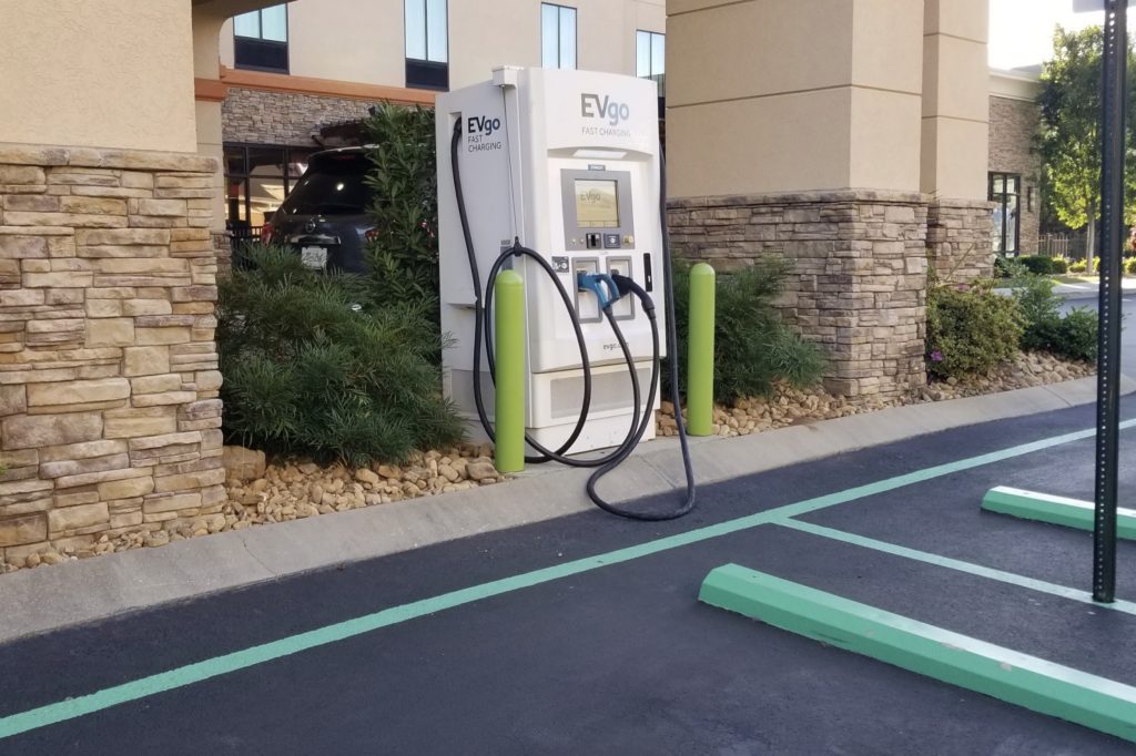 a charging station next to a parking lot