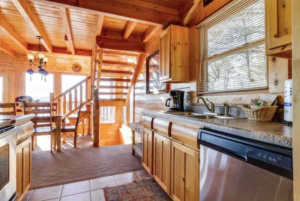 a kitchen with a staircase and a sink