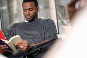man reads book about travel hacking