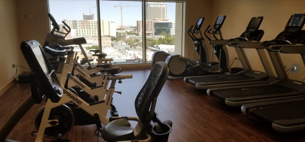 a room with exercise machines and a window
