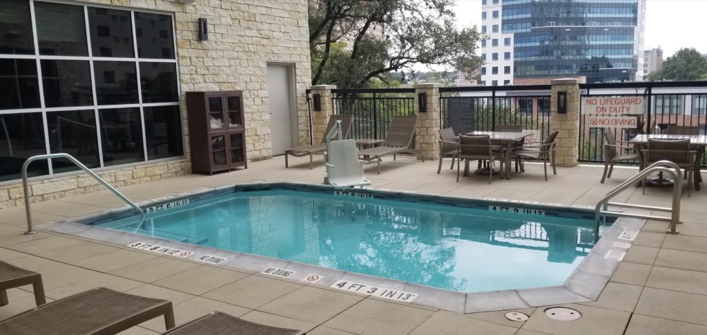 a pool with chairs and a table
