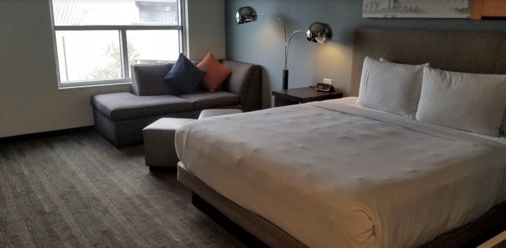 a bedroom with a bed and a couch
