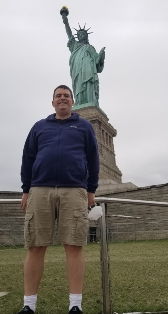 a man standing in front of a statue