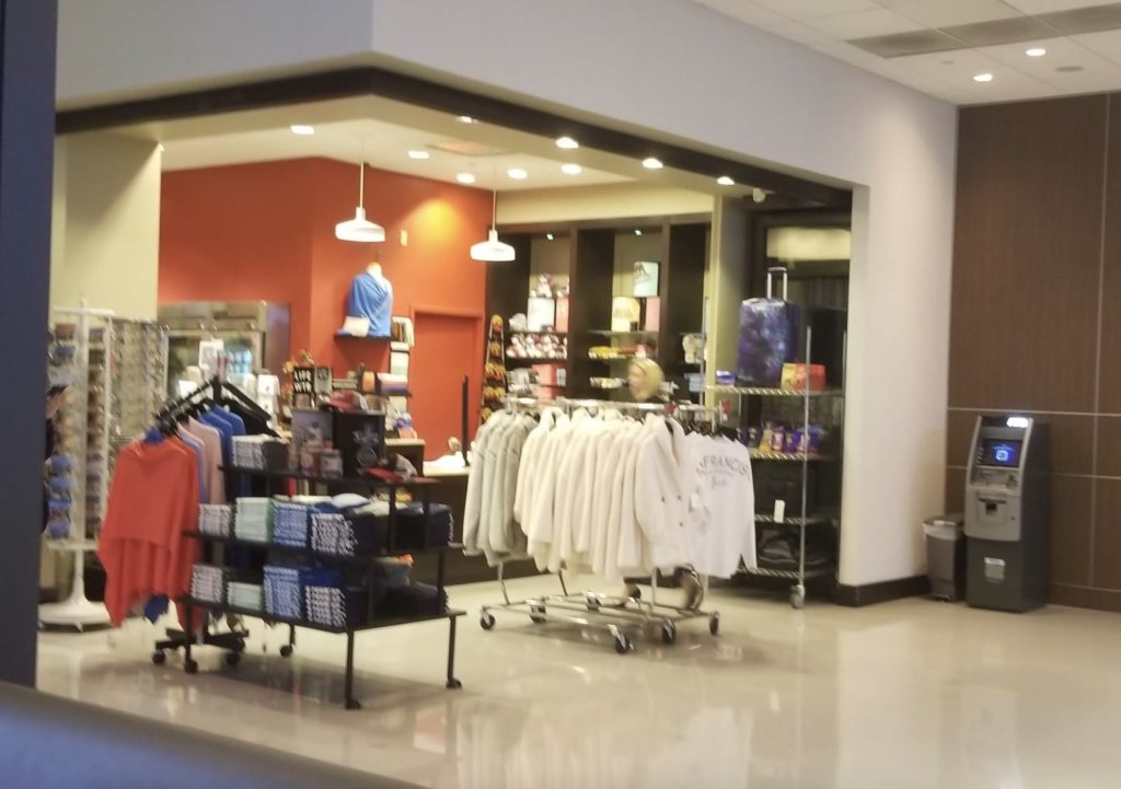 a store with a variety of clothes on swingers